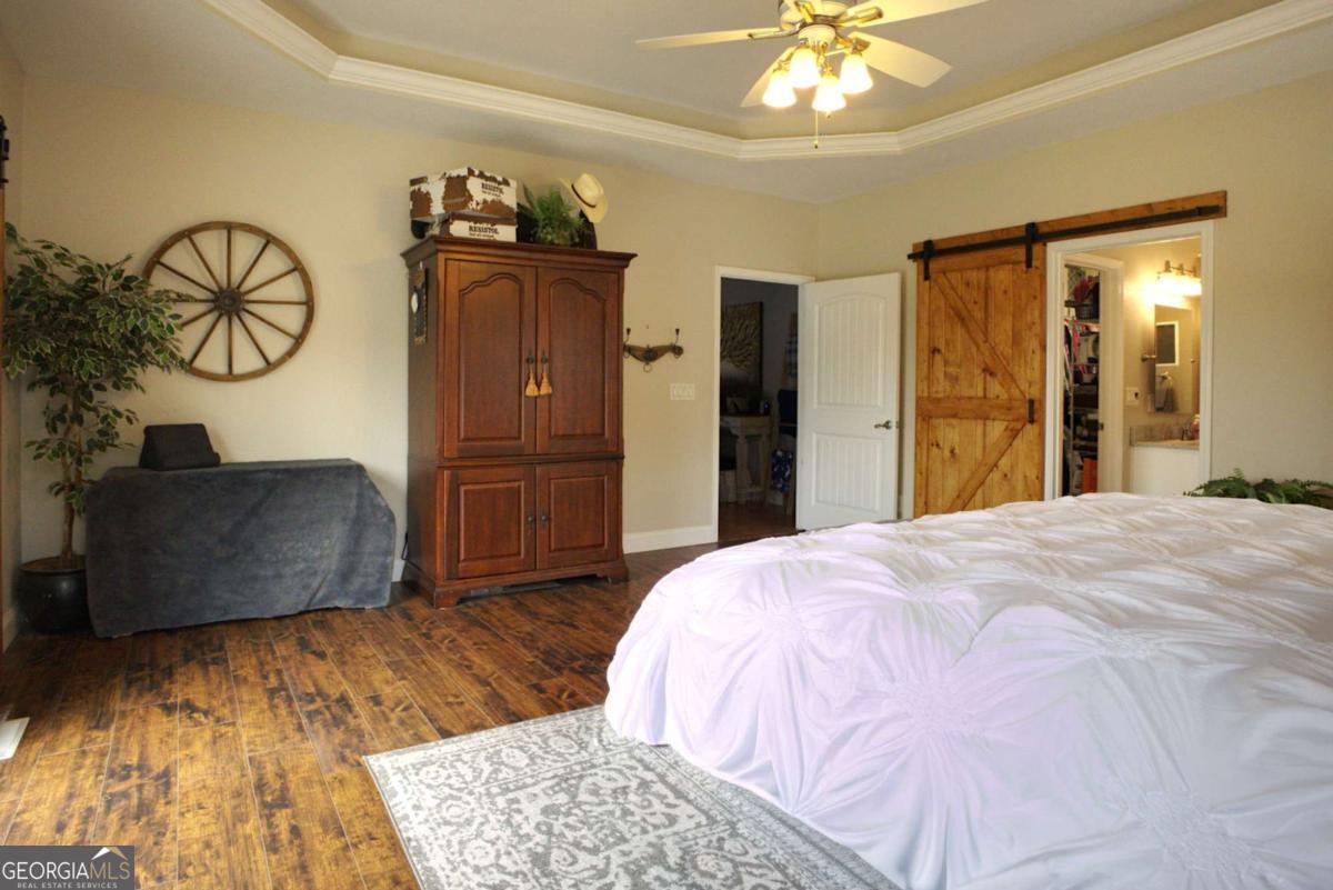 394 Crawford Road, Unit TRK Blairsville, GA 30512 - Photo 20 of 78 a bedroom with a bed and a chandelier