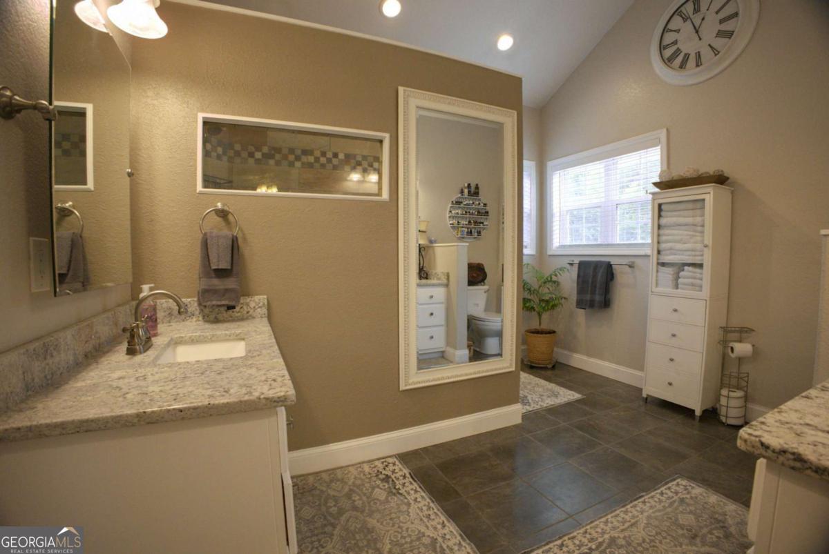394 Crawford Road, Unit TRK Blairsville, GA 30512 - Photo 21 of 78 a bathroom with a granite countertop sink a mirror and shower