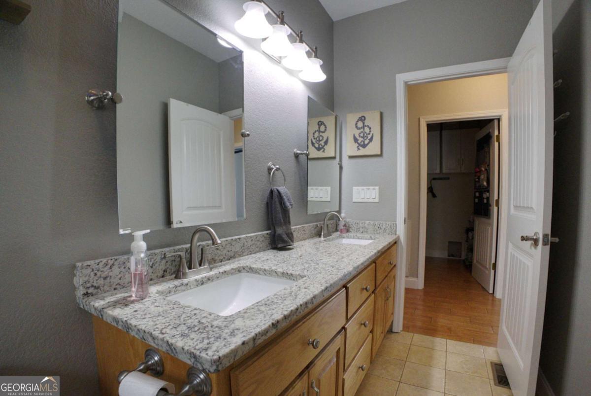 394 Crawford Road, Unit TRK Blairsville, GA 30512 - Photo 27 of 78 a bathroom with a granite countertop sink and a mirror