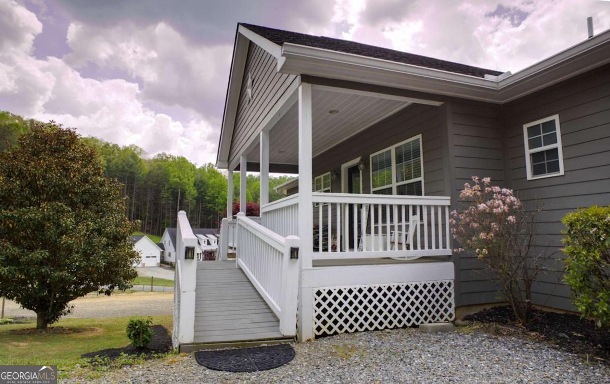 394 Crawford Road, Unit TRK Blairsville, GA 30512 - Photo 6 of 78 a view of a house with a small yard and wooden fence