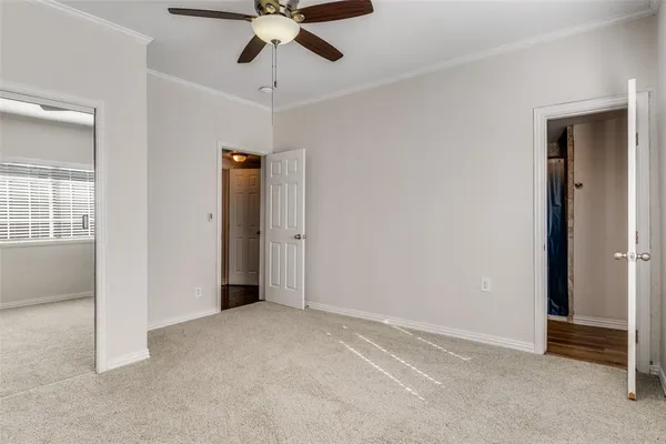 an empty room with closet and windows