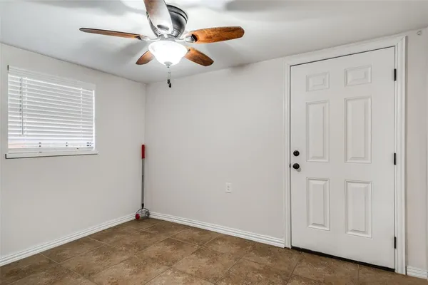an empty room with closet and fan