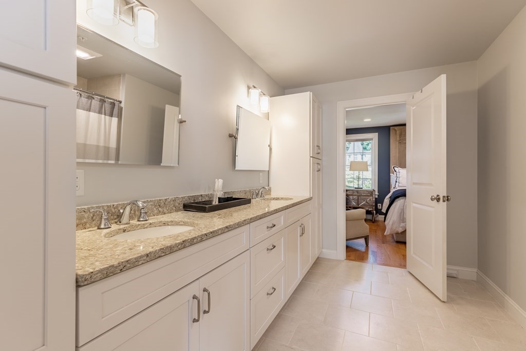 176 Main Street, Unit 3 Medway, MA 02053 - Photo 16 of 28 a spacious bathroom with a granite countertop sink and a mirror