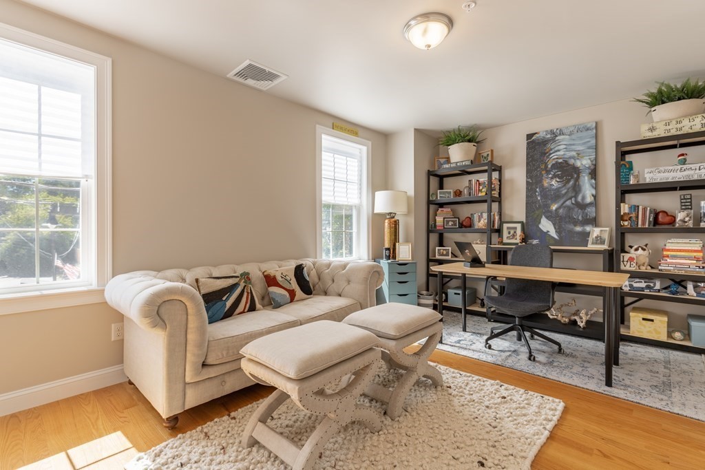 176 Main Street, Unit 3 Medway, MA 02053 - Photo 18 of 28 a living room with furniture and a book shelf