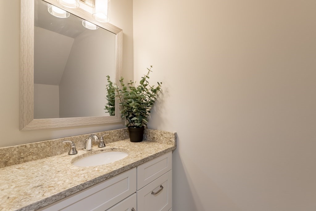 176 Main Street, Unit 3 Medway, MA 02053 - Photo 20 of 28 a bathroom with a granite countertop sink and a mirror