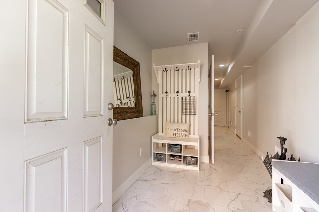 176 Main Street, Unit 3 Medway, MA 02053 - Photo 23 of 28 a view of a livingroom with wooden furniture and staircase