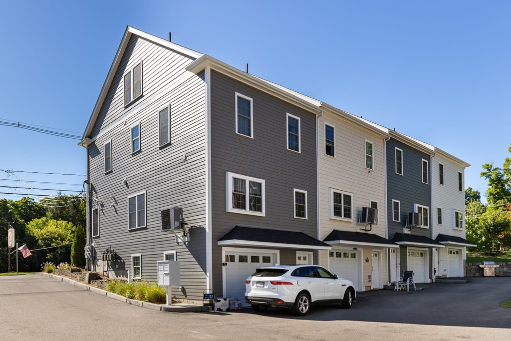 176 Main Street, Unit 3 Medway, MA 02053 - Photo 26 of 28 a car parked in front of a house