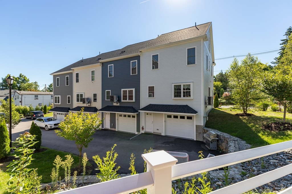 176 Main Street, Unit 3 Medway, MA 02053 - Photo 28 of 28 a front view of a house with a yard and black garden