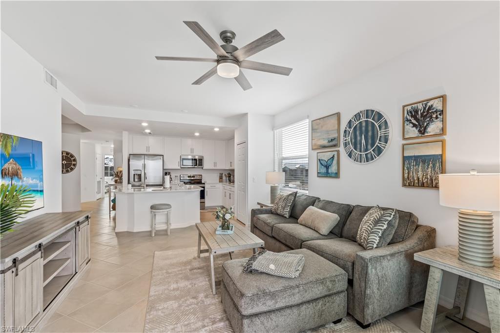 43997 Boardwalk Loop, Unit 1821 Babcock Ranch, FL 33982 - Photo 2 of 14 a living room with furniture and a large window