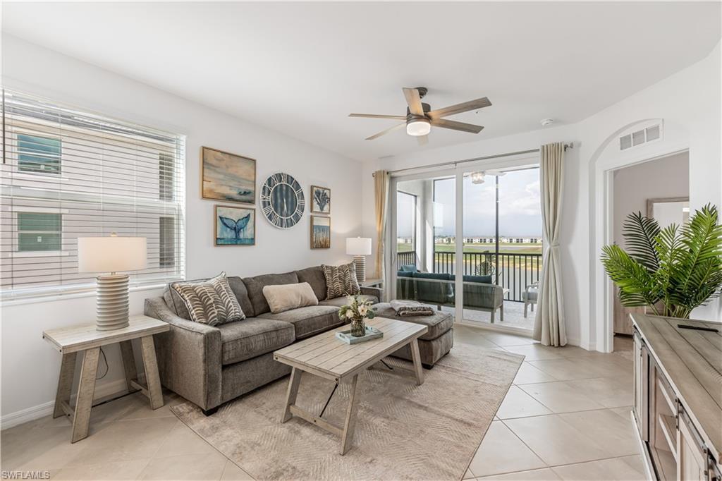 43997 Boardwalk Loop, Unit 1821 Babcock Ranch, FL 33982 - Photo 3 of 14 a living room with furniture potted plant and a large window