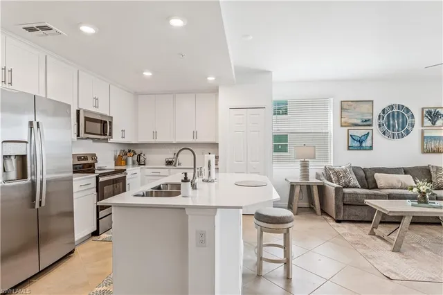 a kitchen with stainless steel appliances kitchen island granite countertop a sink and cabinets