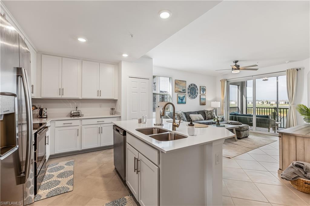 43997 Boardwalk Loop, Unit 1821 Babcock Ranch, FL 33982 - Photo 7 of 14 a kitchen with a sink stove and cabinets