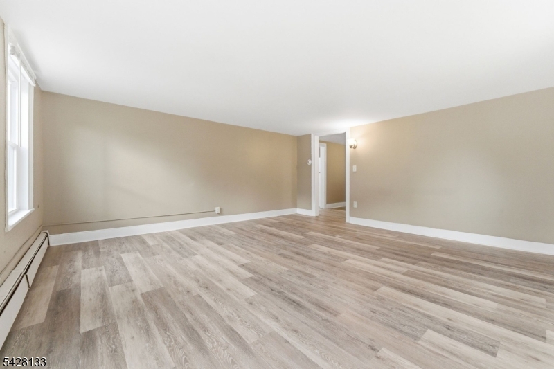 58 Bridge Street Milford, NJ 08848 - Photo 3 of 13 wooden floor in an empty room with a window