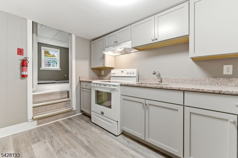 58 Bridge Street Milford, NJ 08848 - Photo 5 of 13 a kitchen with granite countertop cabinets and white appliances