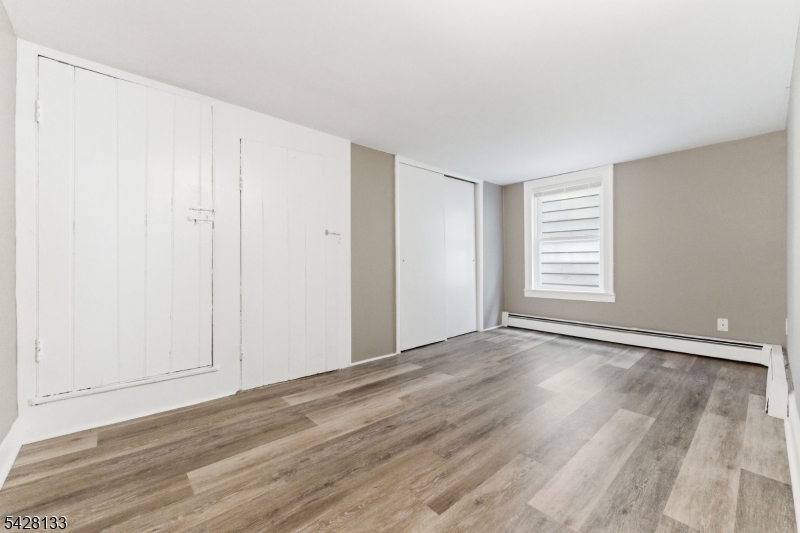 58 Bridge Street Milford, NJ 08848 - Photo 8 of 13 a view of an empty room with wooden floor and a window