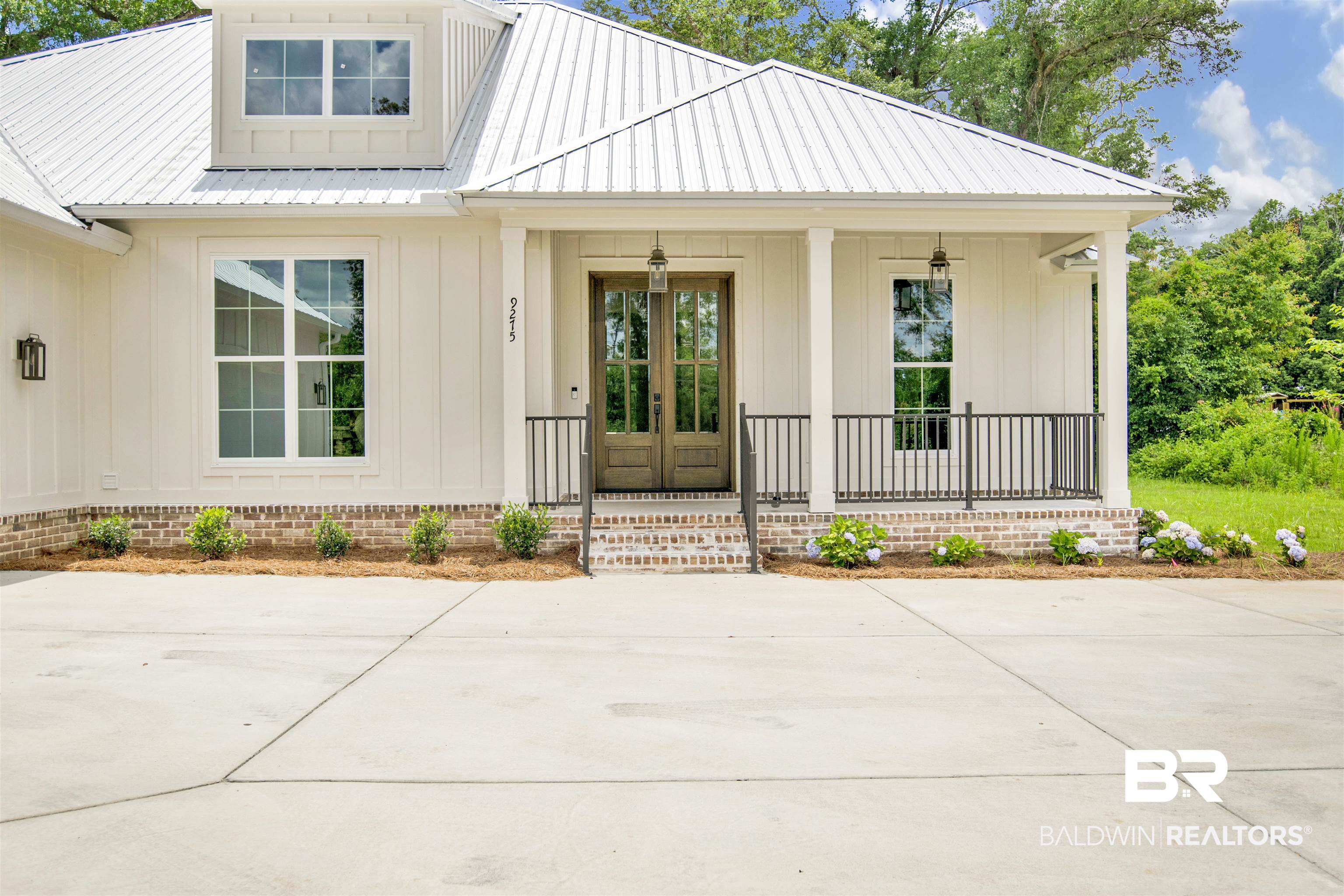 9275 Clarke Ridge Road Foley, AL 36535 - Photo 5 of 43 Property entrance featuring covered porch, board and batten siding, and metal roof