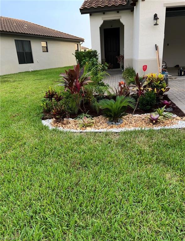 5474 Cassidy Lane Ave Maria, FL 34142 - Photo 2 of 31 a front view of a house with a yard