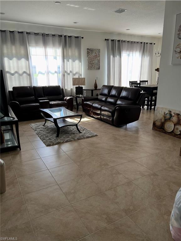 5474 Cassidy Lane Ave Maria, FL 34142 - Photo 5 of 31 a living room with furniture and a large window