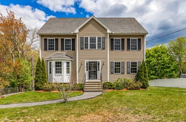 a front view of a house with a yard