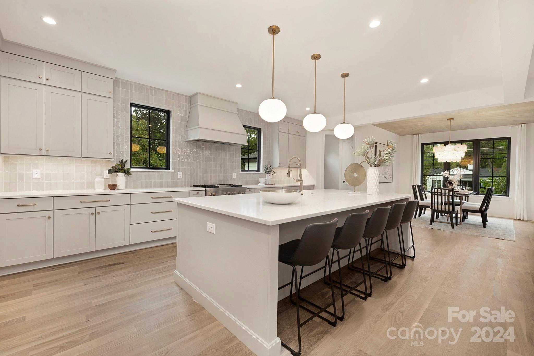 1815 Club Road Charlotte, NC 28205 - Photo 12 of 42 a kitchen with a sink a cabinets and chairs