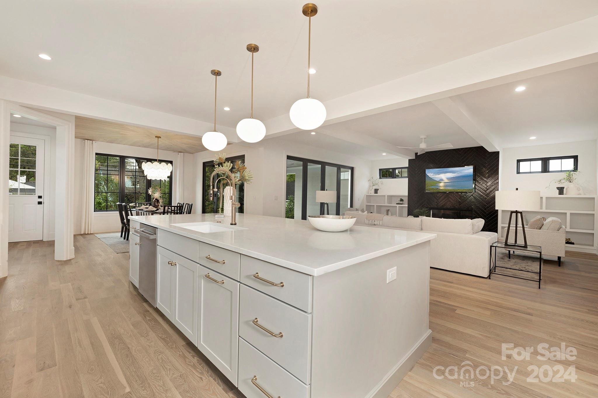 1815 Club Road Charlotte, NC 28205 - Photo 13 of 42 a large kitchen with kitchen island a sink a counter space and stainless steel appliances