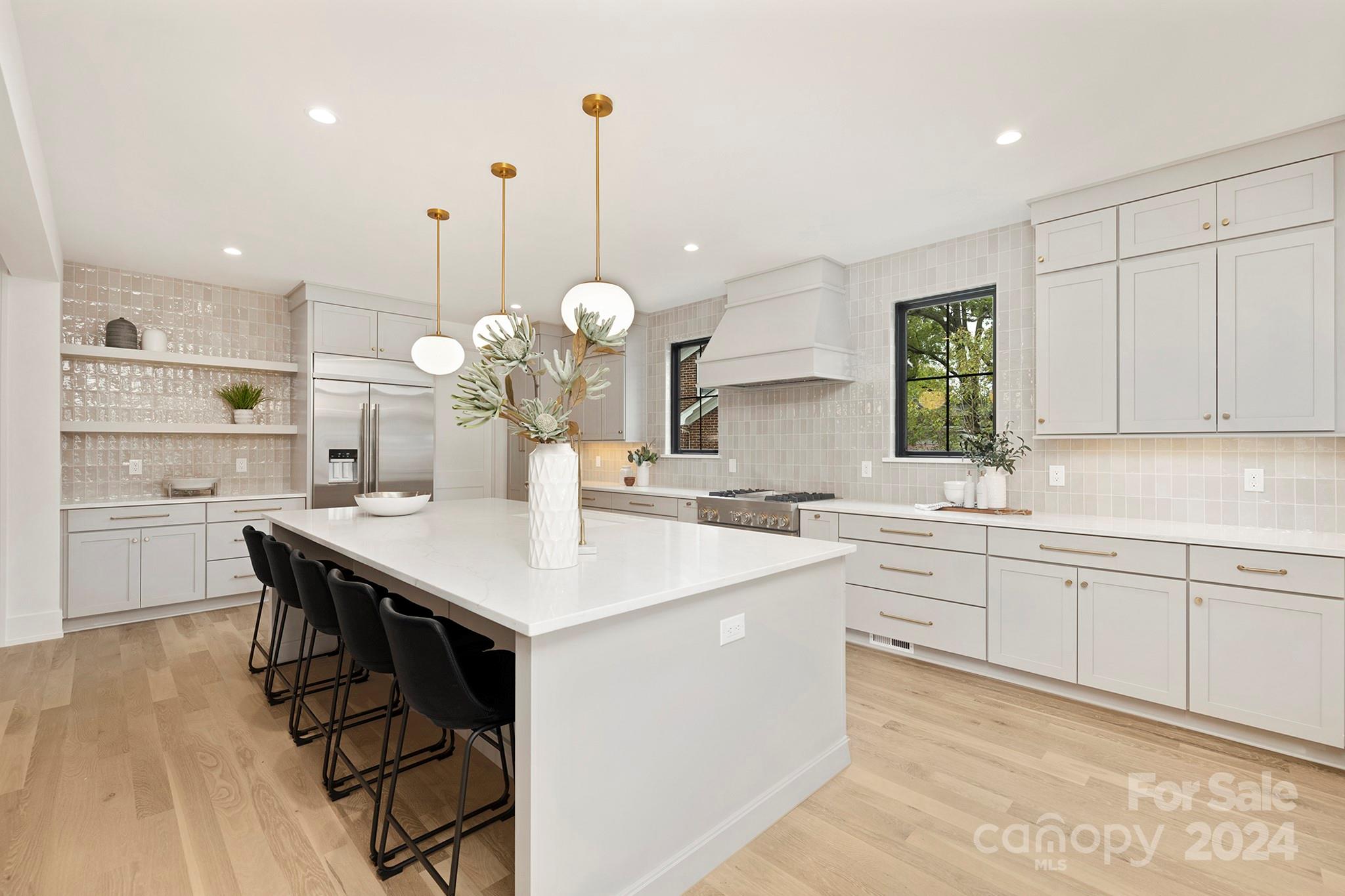1815 Club Road Charlotte, NC 28205 - Photo 14 of 42 a large kitchen with kitchen island a sink table and chairs
