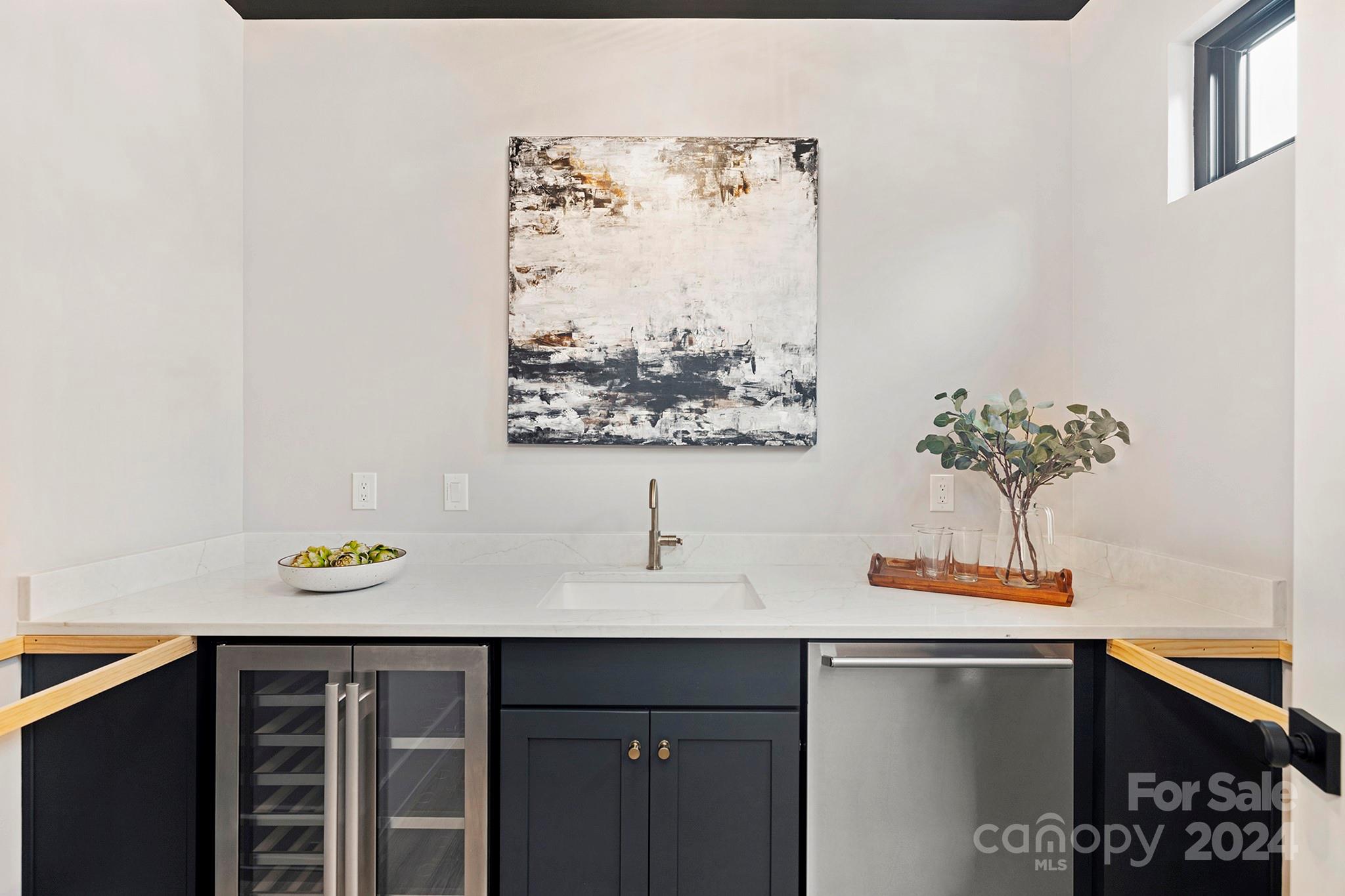 1815 Club Road Charlotte, NC 28205 - Photo 17 of 42 a view of a kitchen with a sink and a potted plant