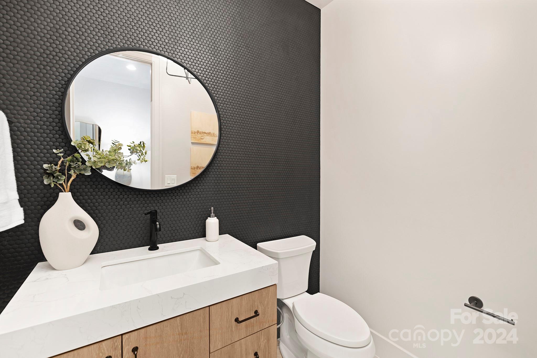 1815 Club Road Charlotte, NC 28205 - Photo 19 of 42 a bathroom with a toilet sink and mirror