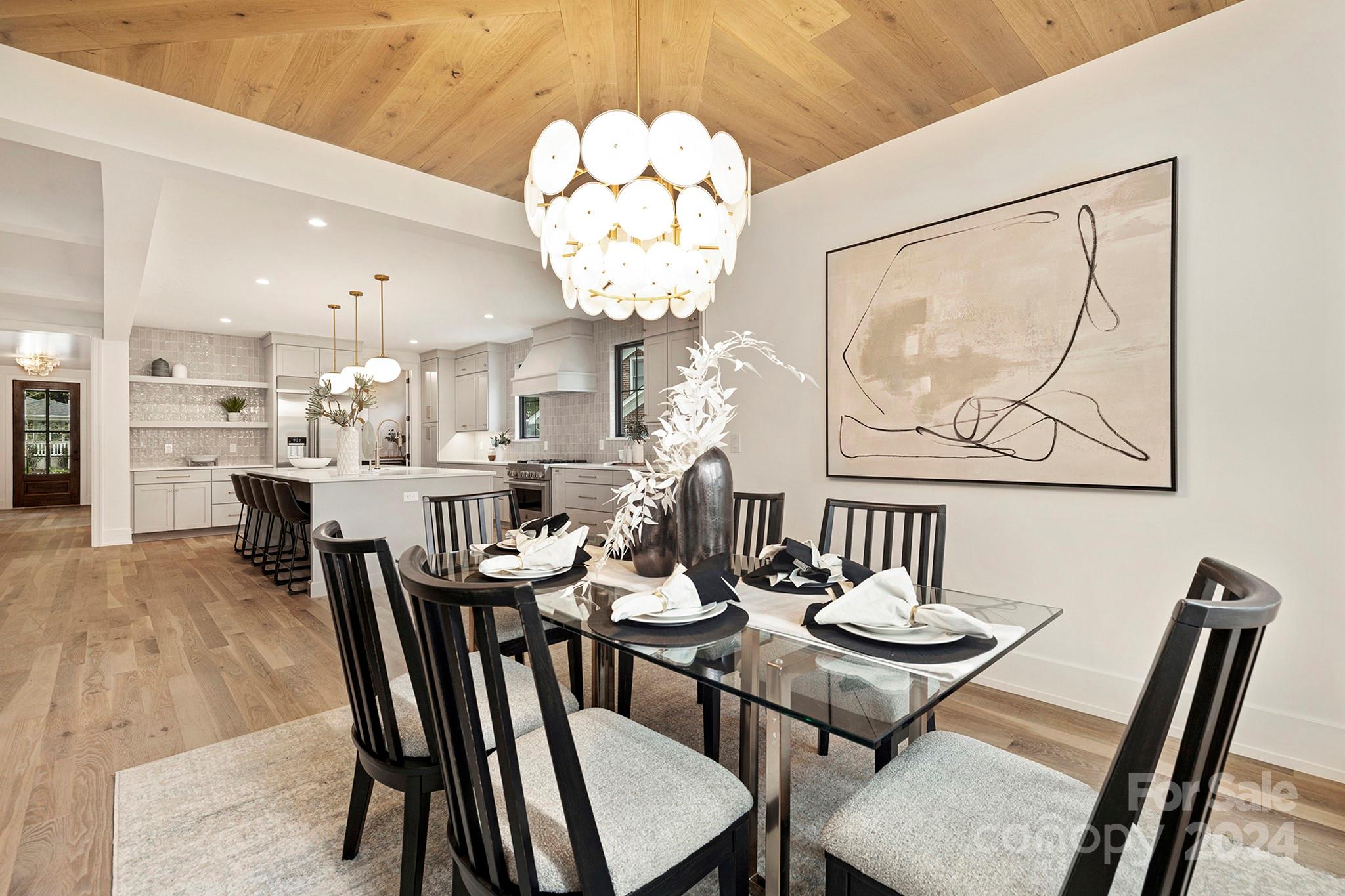 1815 Club Road Charlotte, NC 28205 - Photo 20 of 42 a view of a dining room with furniture and a chandelier