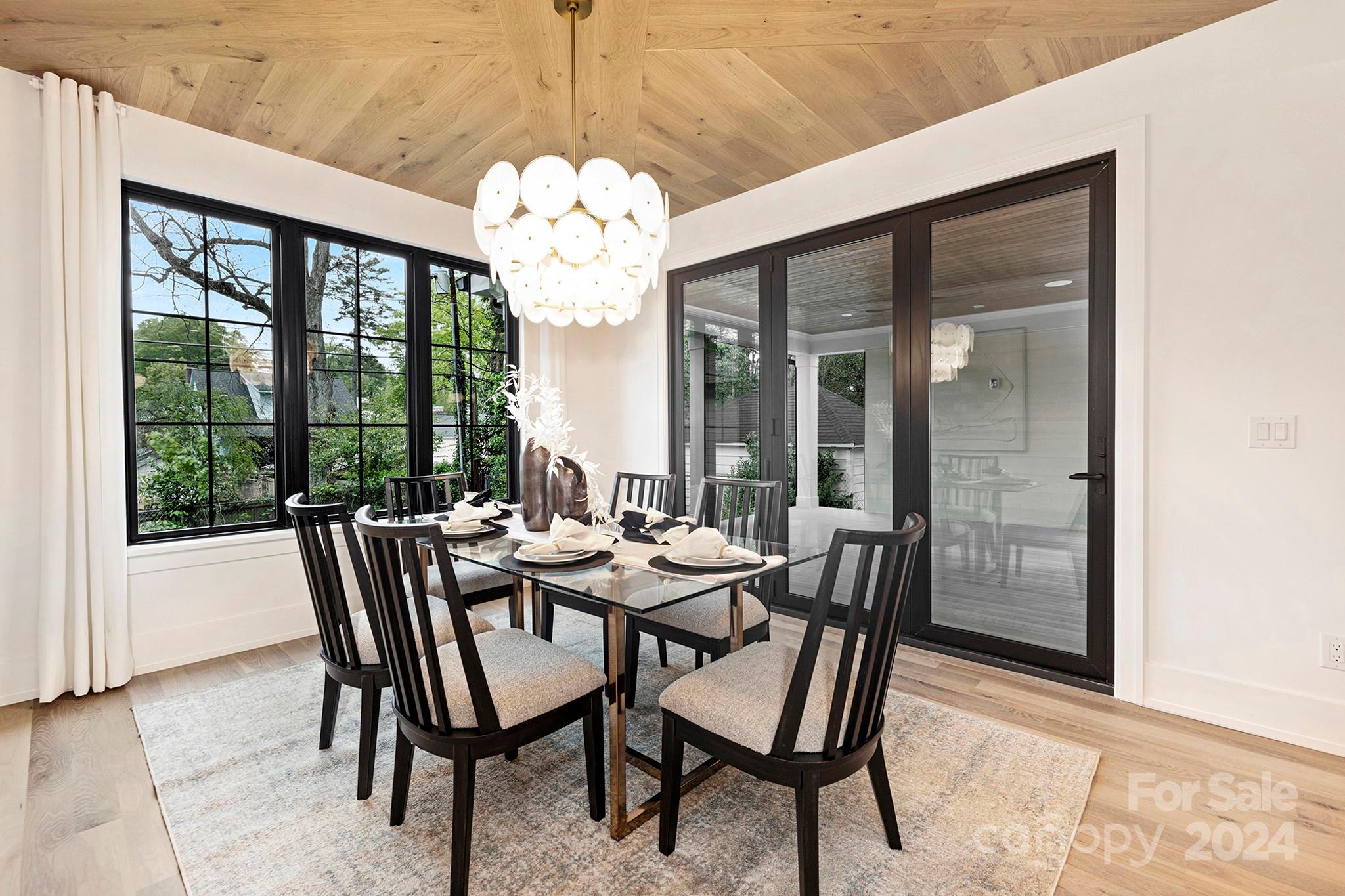 1815 Club Road Charlotte, NC 28205 - Photo 21 of 42 a view of a dining room with furniture large windows and wooden floor