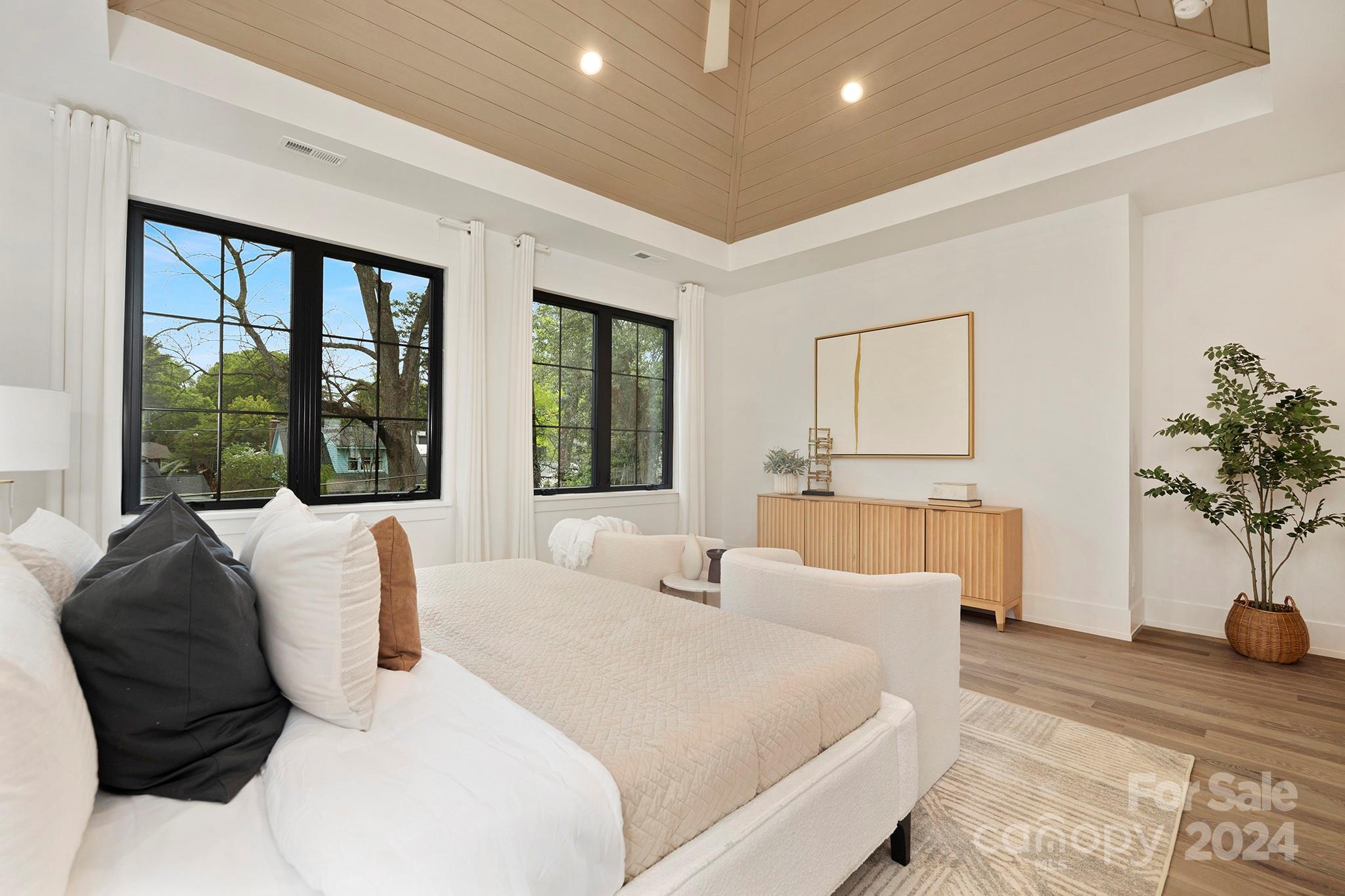 1815 Club Road Charlotte, NC 28205 - Photo 24 of 42 a bedroom with a large bed and a potted plant