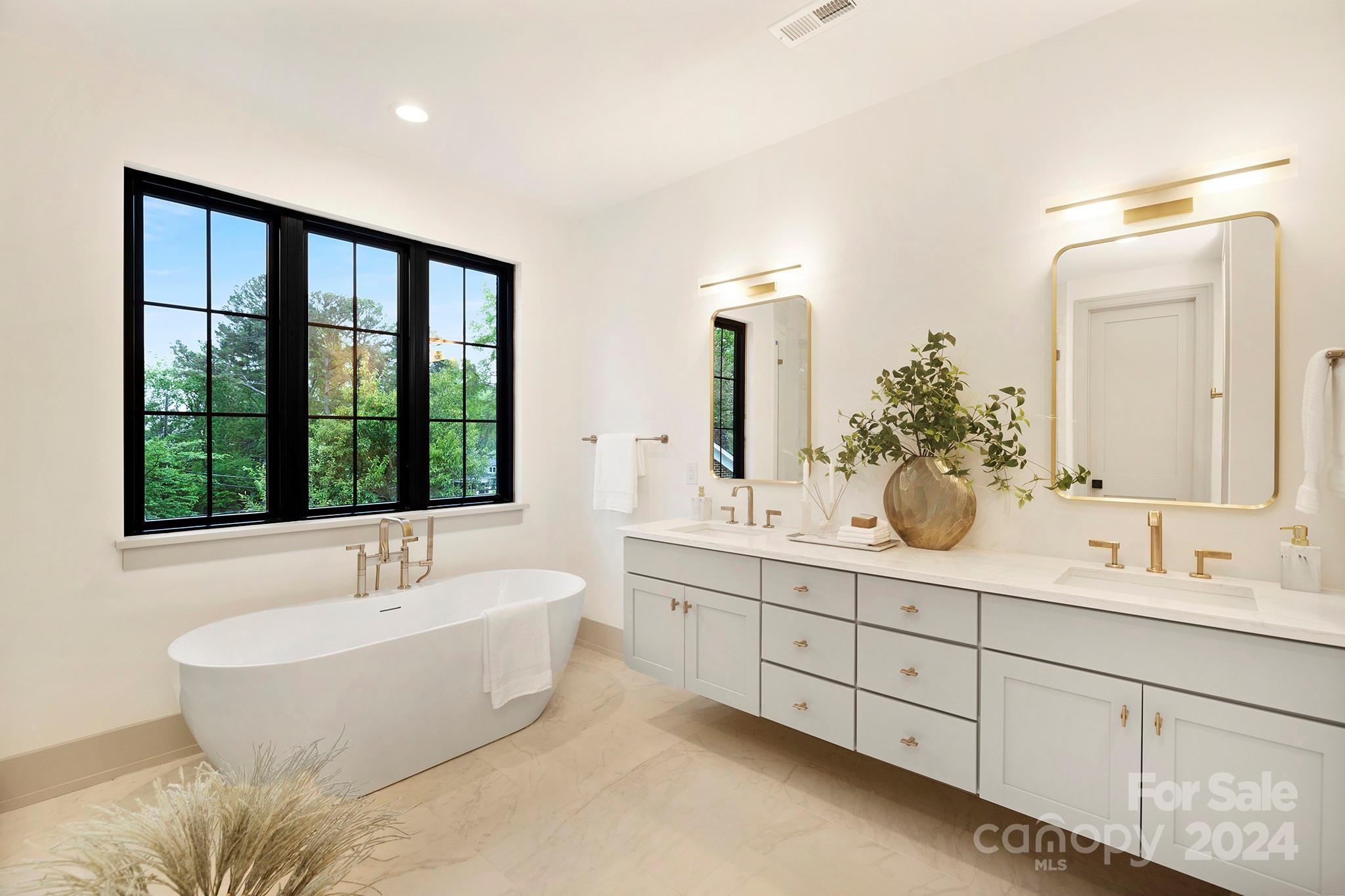 1815 Club Road Charlotte, NC 28205 - Photo 27 of 42 a bathroom with a double vanity sink and a large mirror