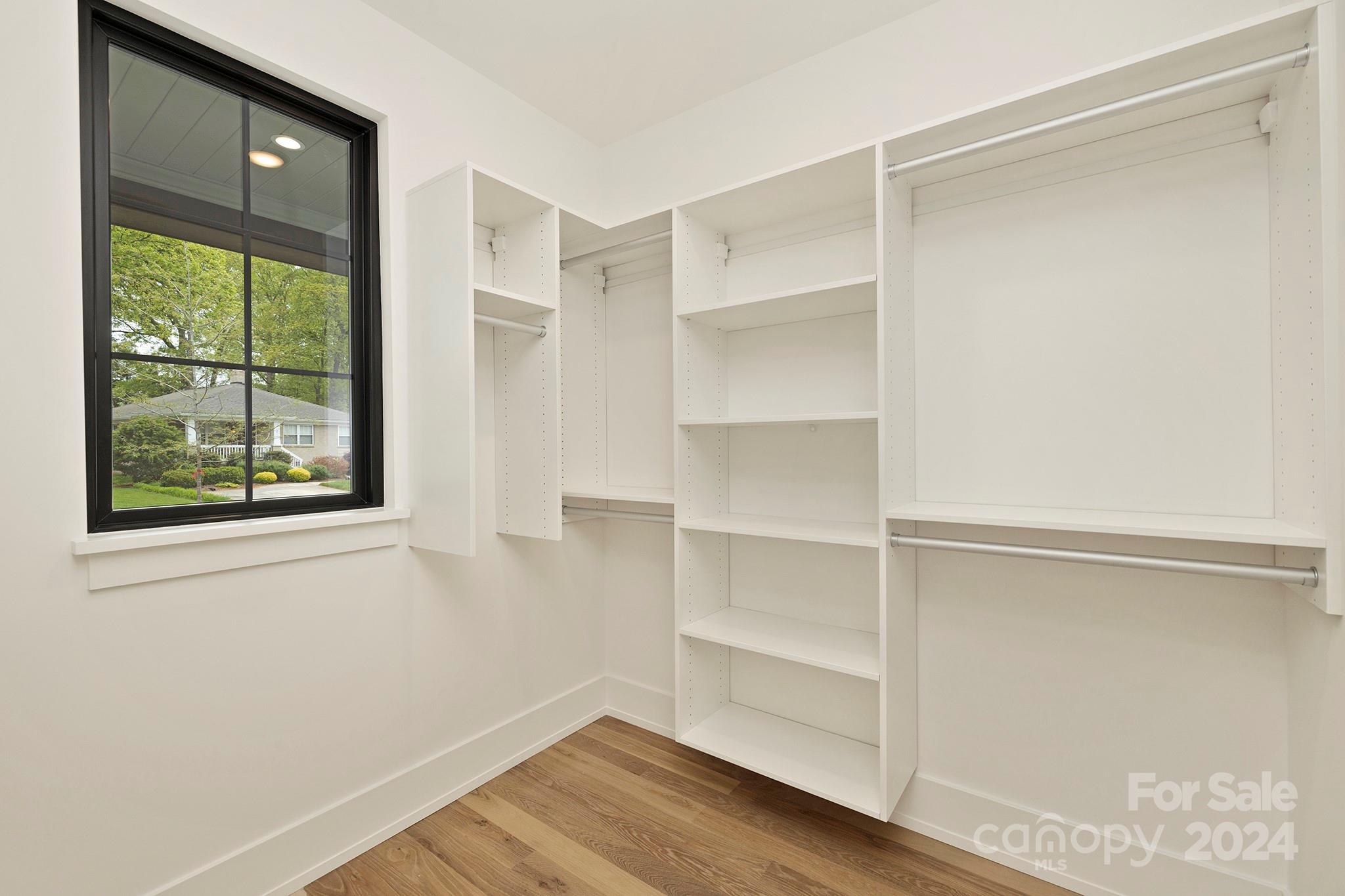 1815 Club Road Charlotte, NC 28205 - Photo 32 of 42 a view of walk in closet with empty racks