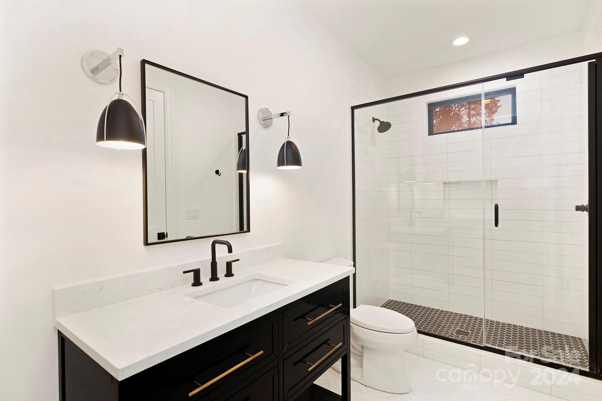 1815 Club Road Charlotte, NC 28205 - Photo 33 of 42 a bathroom with a sink a toilet and shower