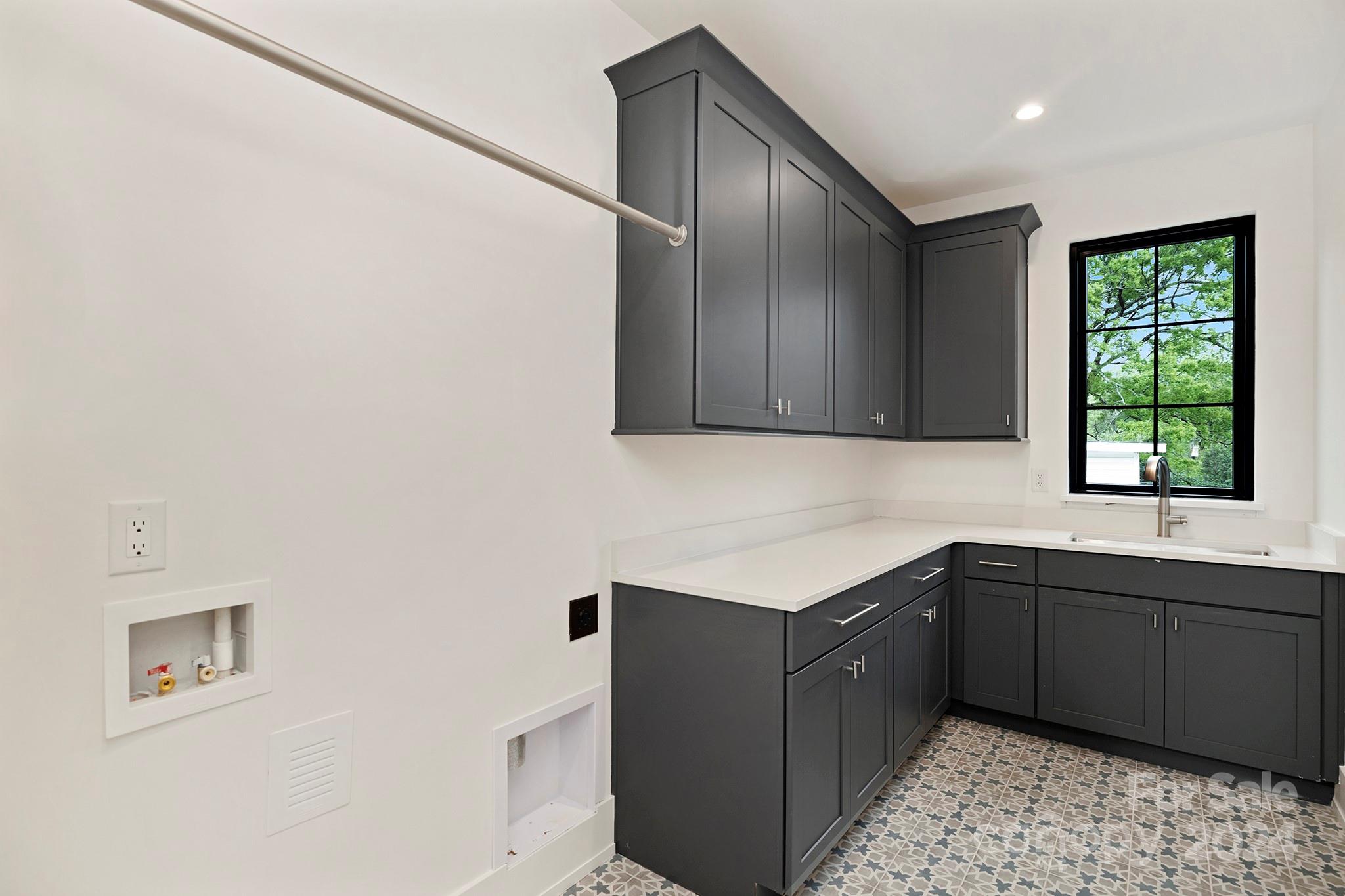 1815 Club Road Charlotte, NC 28205 - Photo 34 of 42 a kitchen with a sink window and cabinets