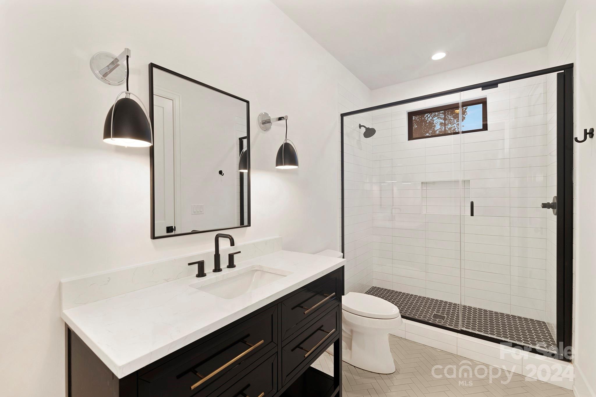 1815 Club Road Charlotte, NC 28205 - Photo 35 of 42 a bathroom with a sink a toilet and shower