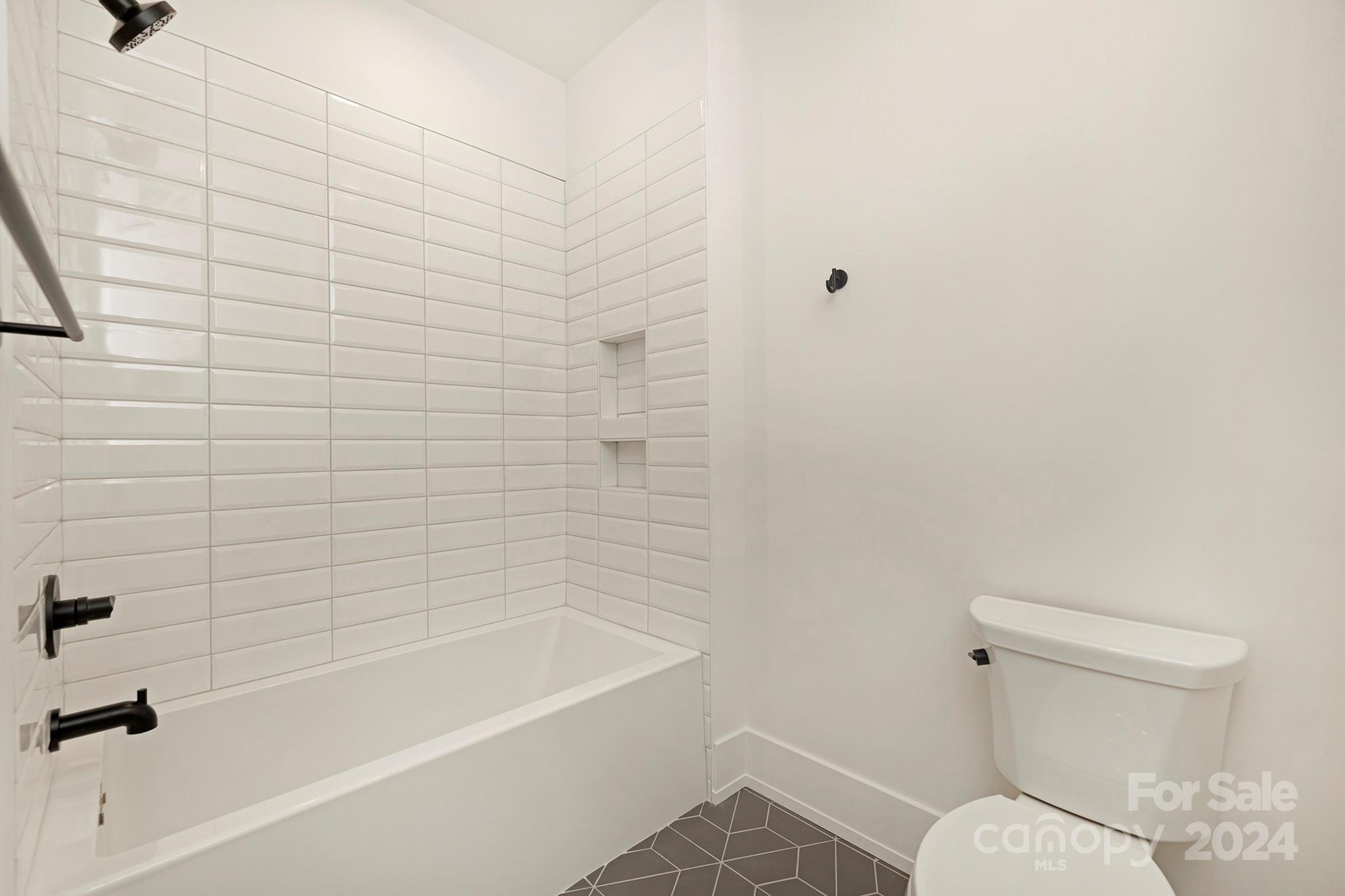 1815 Club Road Charlotte, NC 28205 - Photo 37 of 42 a bathroom with a toilet and a bathtub