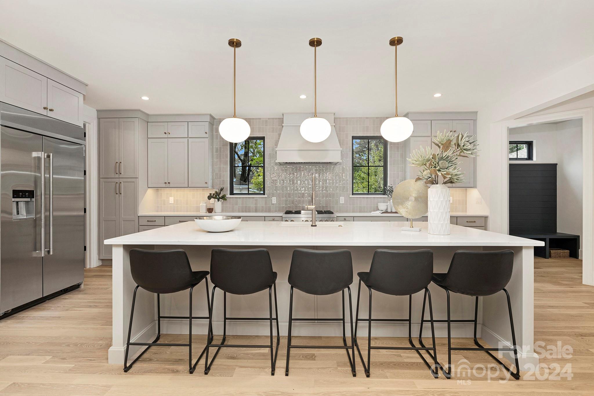 1815 Club Road Charlotte, NC 28205 - Photo 9 of 42 a kitchen with a dining table chairs and white cabinets