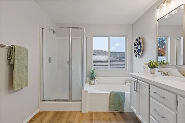 a bathroom with a tub sink and mirror