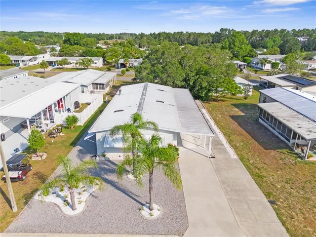an aerial view of residential houses with outdoor space and ocean view