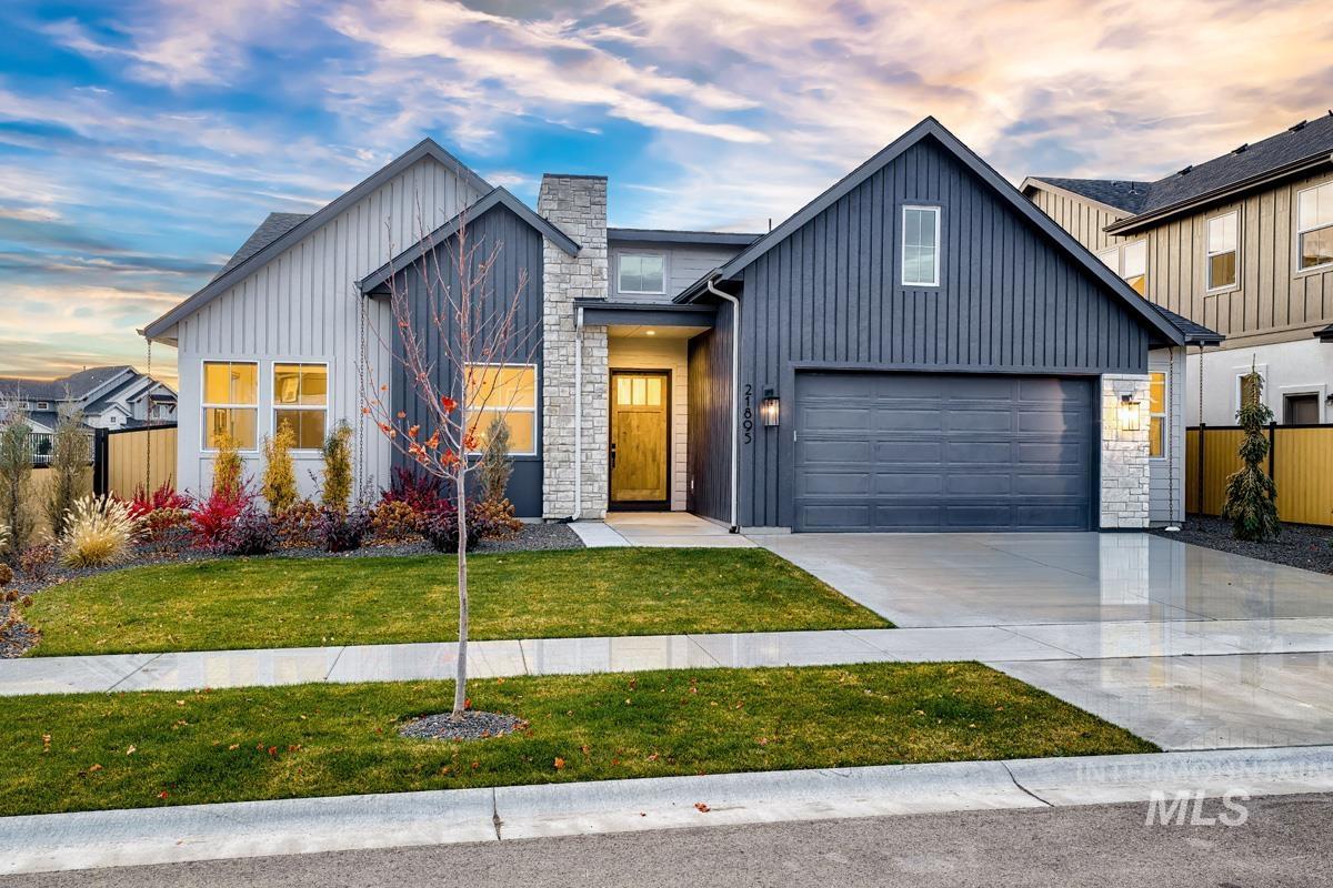 21895 Paint Avenue Star, ID 83669 - Photo 1 of 35 Modern farmhouse style home with concrete driveway, stone siding, board and batten siding, and a garage