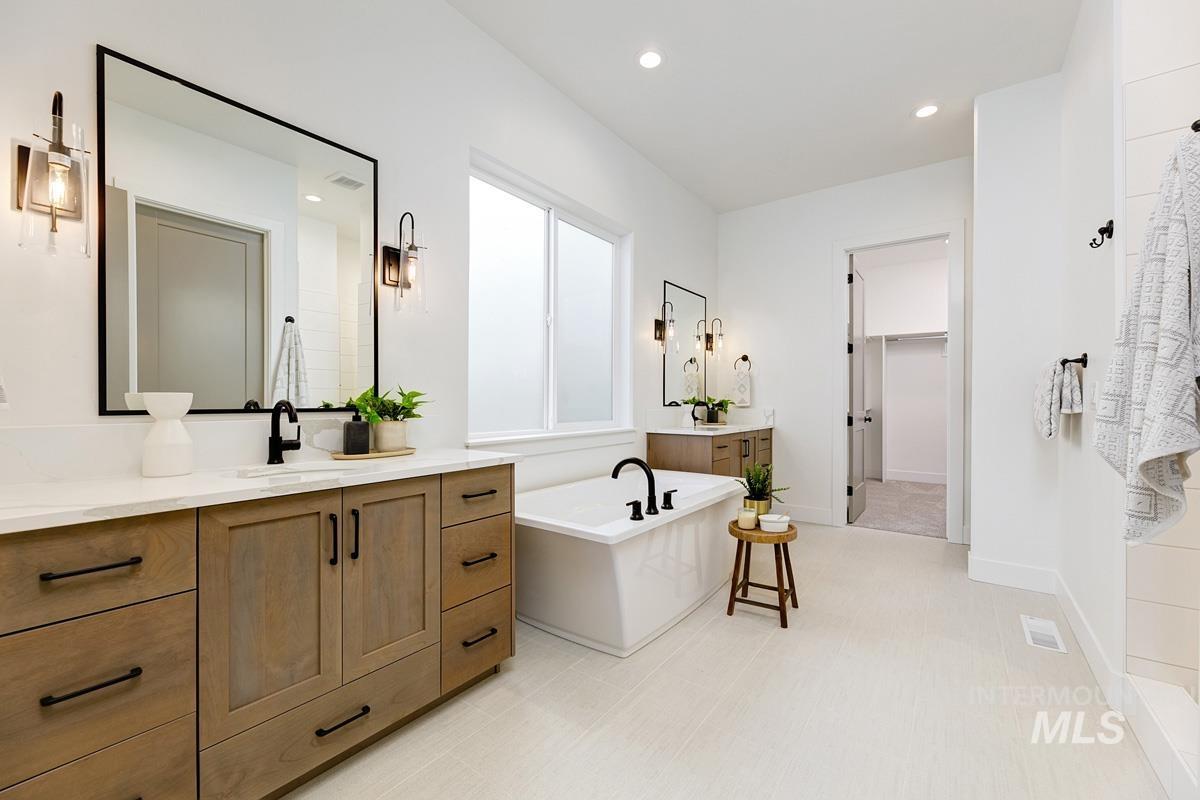 21895 Paint Avenue Star, ID 83669 - Photo 15 of 35 Full bathroom featuring vanity, a freestanding bath, a spacious closet, and recessed lighting
