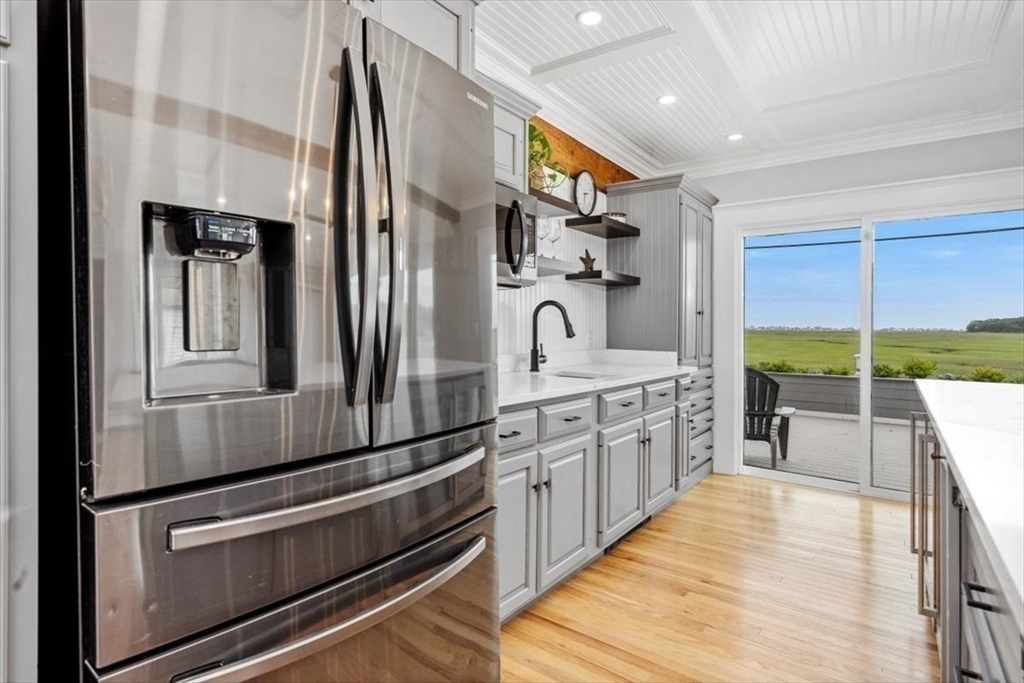 76 Macombers Way Marshfield, MA 02050 - Photo 11 of 41 a kitchen with stainless steel appliances granite countertop a refrigerator and a stove top oven