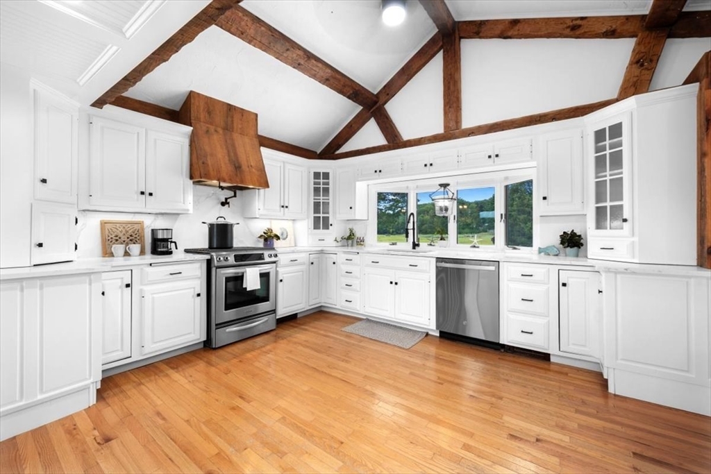 76 Macombers Way Marshfield, MA 02050 - Photo 13 of 41 a kitchen with white cabinets and white appliances