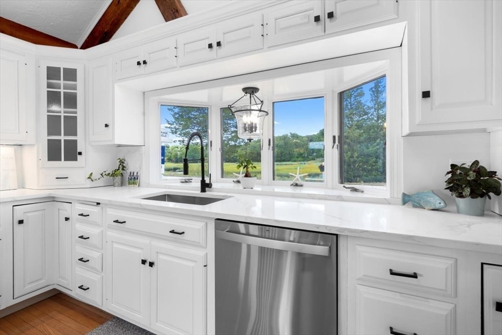 76 Macombers Way Marshfield, MA 02050 - Photo 15 of 41 a kitchen with granite countertop a sink and a window