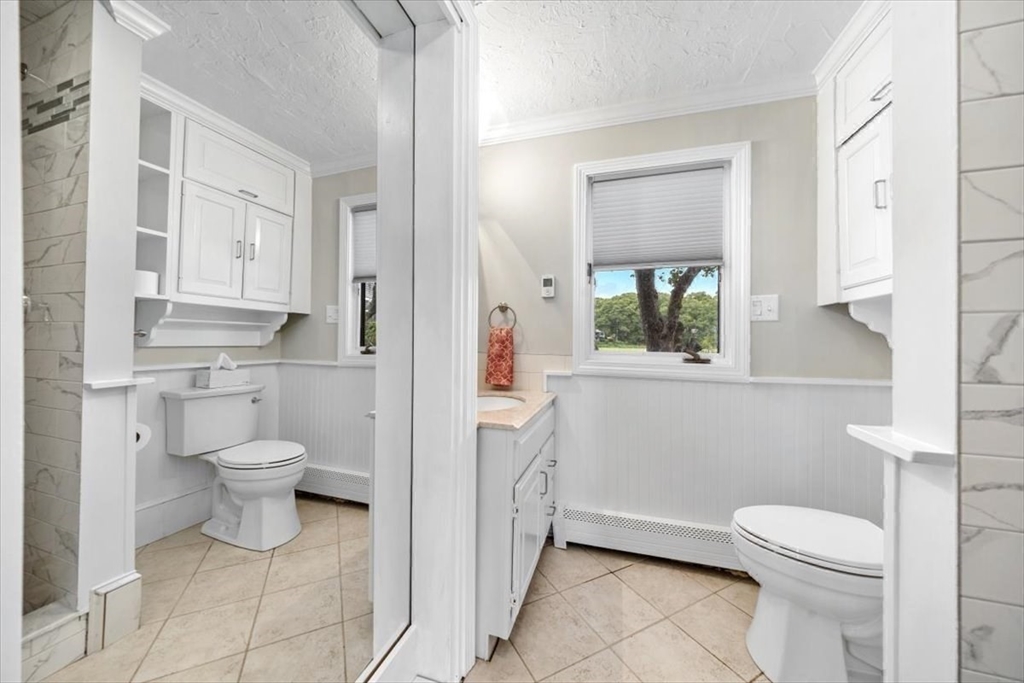 76 Macombers Way Marshfield, MA 02050 - Photo 22 of 41 a bathroom with a toilet a sink and a window