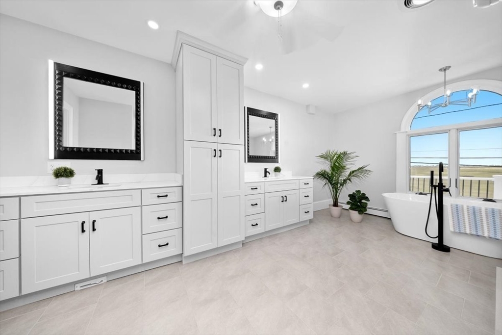 76 Macombers Way Marshfield, MA 02050 - Photo 30 of 41 a spacious en suite bathroom with a double vanity sink a mirror and a potted plant
