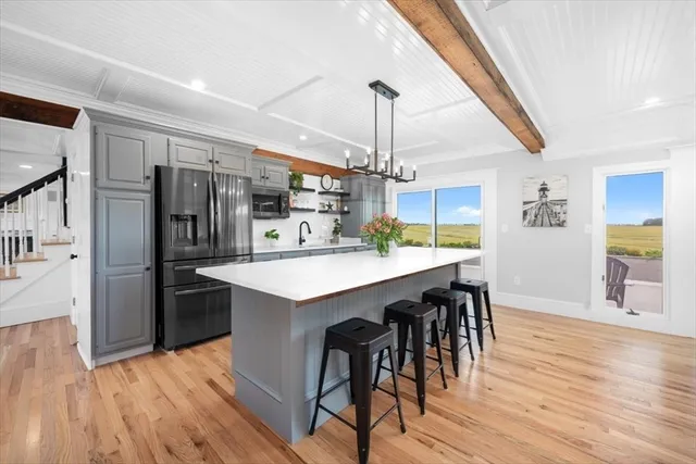 a kitchen with stainless steel appliances granite countertop a refrigerator and a stove top oven