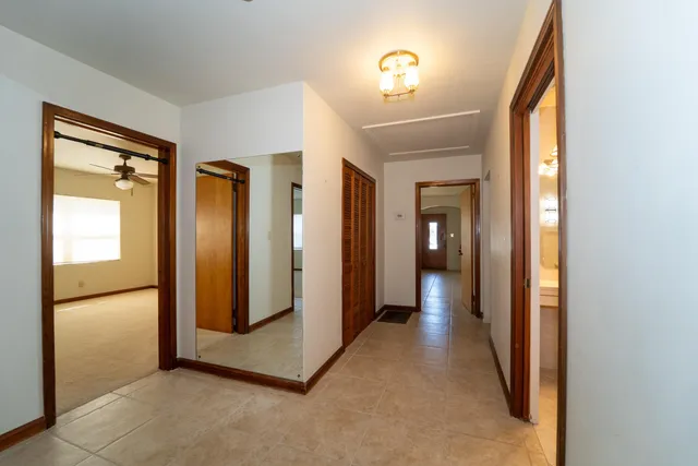 a view of a hallway with wooden floor and a glass door