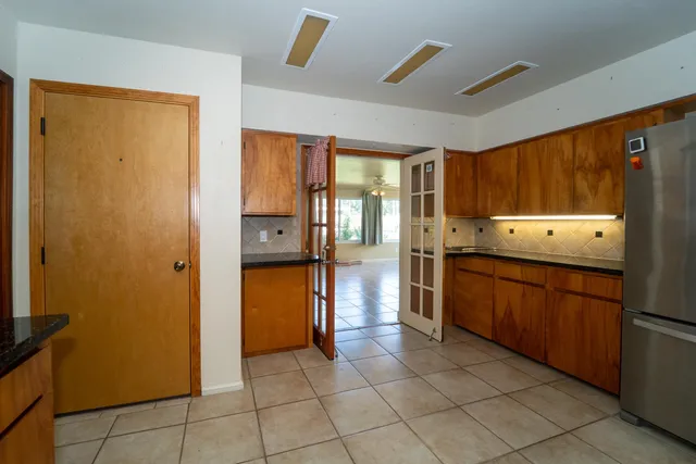 a kitchen with stainless steel appliances granite countertop a refrigerator and a stove